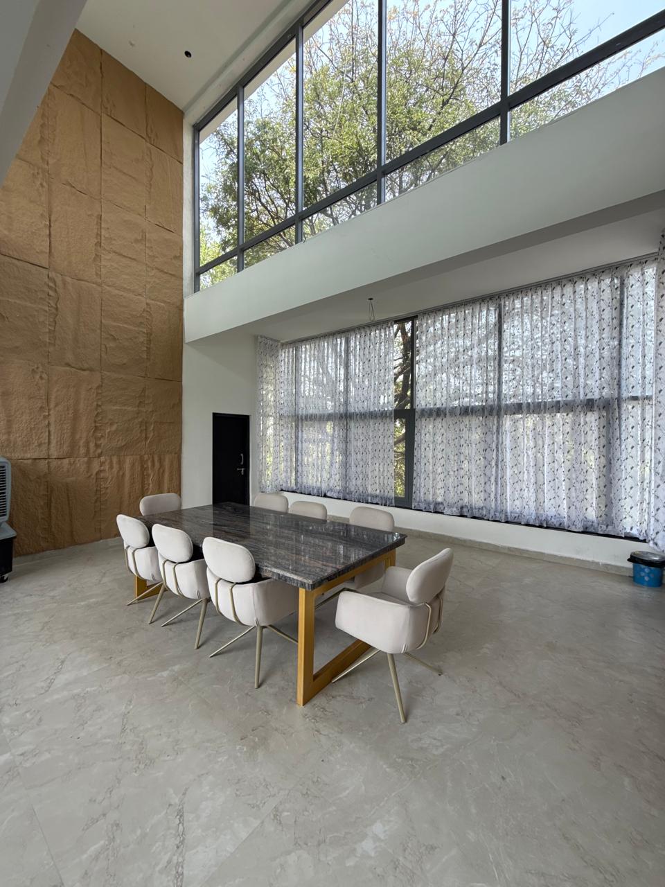 Luxury farmhouse dining hall with glass elevation in Hyderabad