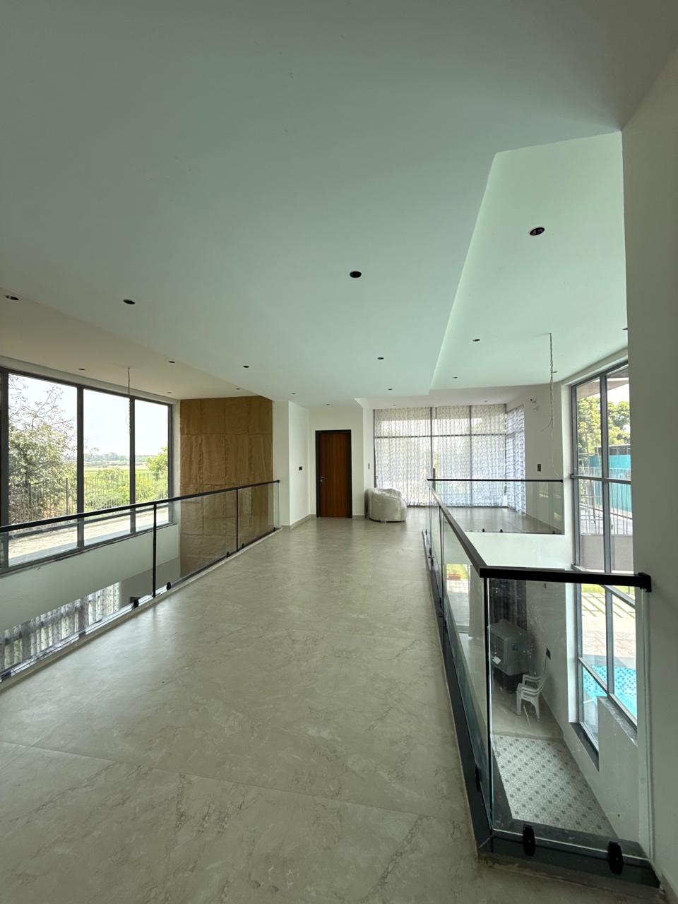 Modern double height glass elevation living area